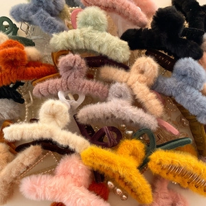 Close-up of colorful plush bear hair scrunchies showing soft texture and elastic design