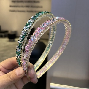 Detail of pink and green crystal headbands with sparkling rhinestones on gold metal