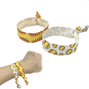 Softball themed elastic hair ties with yellow and white patterns for sports hairstyles