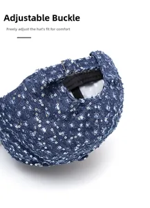 Detail of the metal adjustable buckle on the back of the blue sequin denim baseball cap