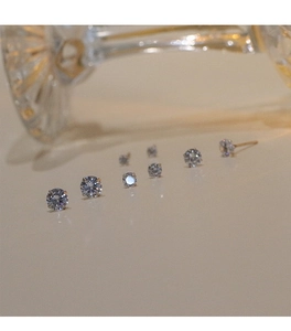 Macro shot of 925 silver cubic zirconia stud earrings in various sizes with reflections