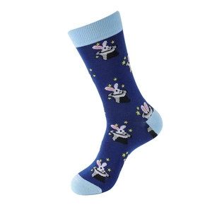 Detail of dark blue cotton sock featuring a magician rabbit in a hat and star patterns