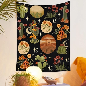 Close-up of tapestry featuring snake, cactus, and moon patterns on a white wall