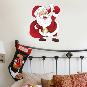 Détail du sticker mural Père Noël en PVC avec sac de cadeaux dans une chambre