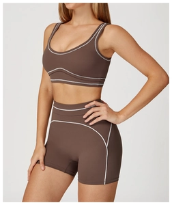 Detail of coffee brown yoga set with white contrast stitching on sports bra and shorts