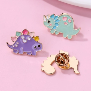 Set of cute cartoon dinosaur enamel pins with colorful designs and butterfly clutch back