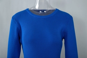 Detail of royal blue ribbed knit texture and round neckline on a fitted dress