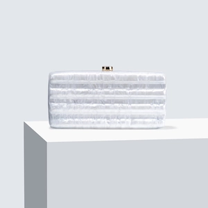Elegant white acrylic evening clutch with marble texture and gold clasp on white stand