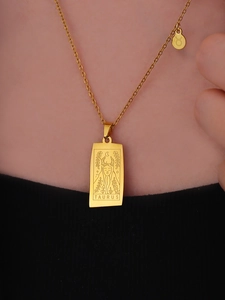 Macro shot of gold Taurus pendant necklace showing fine metallic texture on skin