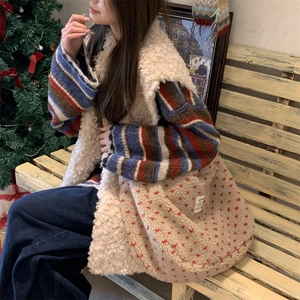 Fuzzy sherpa tote bag with red heart embroidery in a cozy Christmas indoor setting