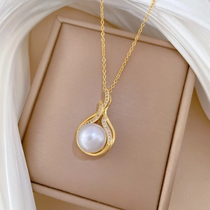 Detail of fishtail pearl necklace with sparkling zircon pavé on beige jewelry box lid