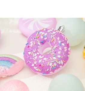 Close-up of purple glitter donut Christmas ornament with colorful sprinkles and hanger