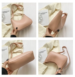 Detail of nude pink half-moon bag showing side stitching and top view on a soft background
