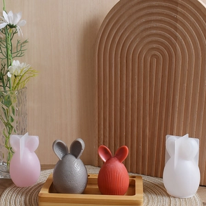 Detailed view of silicone molds for rabbit-shaped Easter egg candles and textured resin crafts