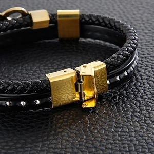 Detail of multi-layer leather bracelet with gold clasp and silver rivets