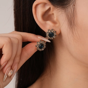 Vintage floral stud earrings with deep blue central stone and sparkling crystal halo