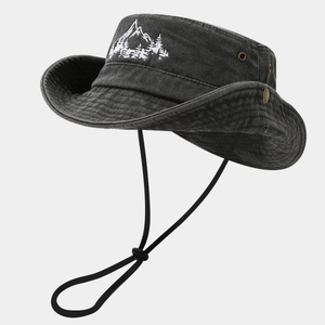 Detail view of washed cotton outdoor hat featuring mountain embroidery and metal eyelets