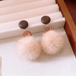 Winter round pompom drop earrings with wooden disc and brown circular stud detail