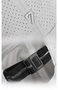 Detail of 3D embroidered number seven and adjustable back strap on grey mesh cap