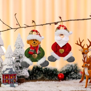 Plush Santa and Bear Christmas ornaments hanging on branches with cozy holiday decor