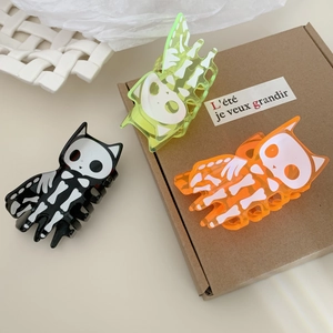 Three Halloween acrylic hair claws with cat skeleton design in black, green, and orange
