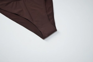 Detailed close-up of dark brown bikini bottom showing fabric texture and neat stitching