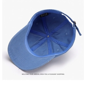 Detail view of the 100% cotton inner lining and adjustable metal buckle on a navy baseball cap