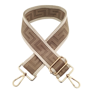 Detail of camel and beige geometric woven wide shoulder strap with gold metal hooks