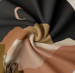 Close-up of soft bohemian tapestry fabric showing abstract lunar and plant patterns