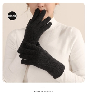 Detail of black knitted gloves with ribbed cuffs and thick thermal lining for winter