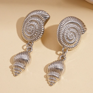 Close-up of silver conch earrings featuring detailed spiral sea shell textures and patterns