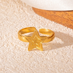 Close-up of a 18k gold plated stainless steel star-shaped open ring on stone