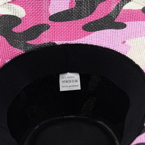 Detail view of pink camo cowboy hat interior with black sweatband and 100% paper label