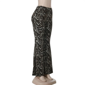 Detail of zebra print flared pants with subtle gold shimmer texture and vintage style