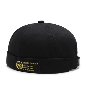 Classic black docker hat with golden totem embroidery and adjustable leather strap back