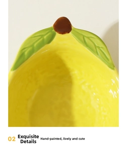 Detail showing hand-painted lemon ceramic hamster bowl with realistic leaf and texture
