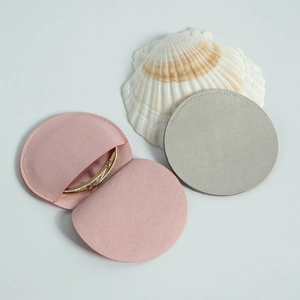 Pink and grey microfibre envelope jewelry pouches with gold bracelet inside