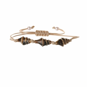 Detail of woven shell bracelet with brown spotted conch beads and adjustable cord
