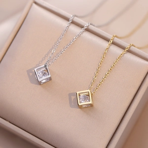 Colliers pendentifs cubes évidés dorés et argentés avec zircones sur boîte à bijoux