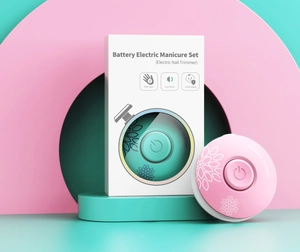 Close-up of portable palm-sized low noise electric nail trimmer set in green and pink colors