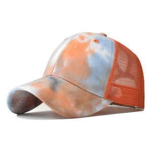 Detail of colorful tie-dye trucker hat featuring breathable orange mesh and reinforced brim
