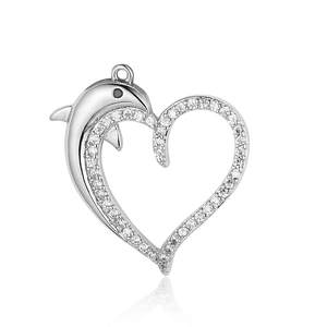 Macro shot of silver-colored heart and dolphin pendant with cubic zirconia stones