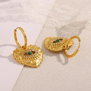 Detail of 18K gold heart earrings featuring green malachite stone and white zircon