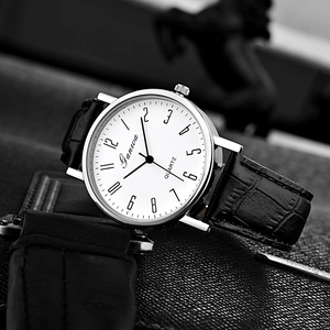 Detailed close-up of Ganova quartz watch with white dial and black leather strap