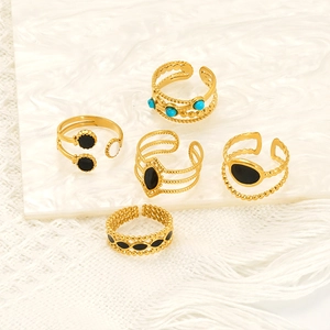 Set of five gold titanium steel flower rings with black and turquoise enamel accents