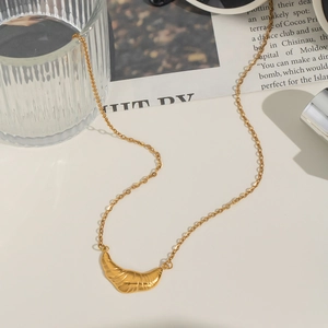 Elegant gold croissant pendant necklace with fine chain and textured geometric design
