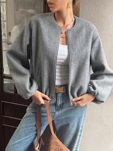 Close-up of a casual grey wool jacket with a stand-up collar and zipper closure