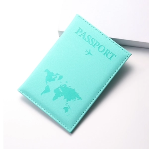 Detail view of mint green PU leather passport holder with embossed world map and airplane
