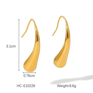 Detailed view of gold teardrop earrings showing 3.1cm height and polished metallic finish