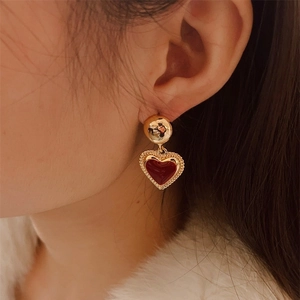 French vintage 18K gold plated red enamel heart drop earrings worn by a model